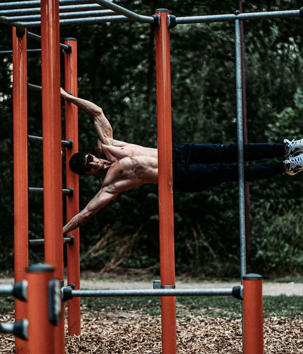 Man performing a controlled strength exercise in a minimalist gym.